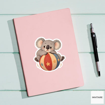 Koala sitting on a rolling ball with paws gripping tightly Vinyl Sticker
