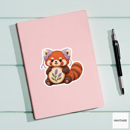 Red Panda wearing yarn around its ears while holding a hoop Vinyl Sticker