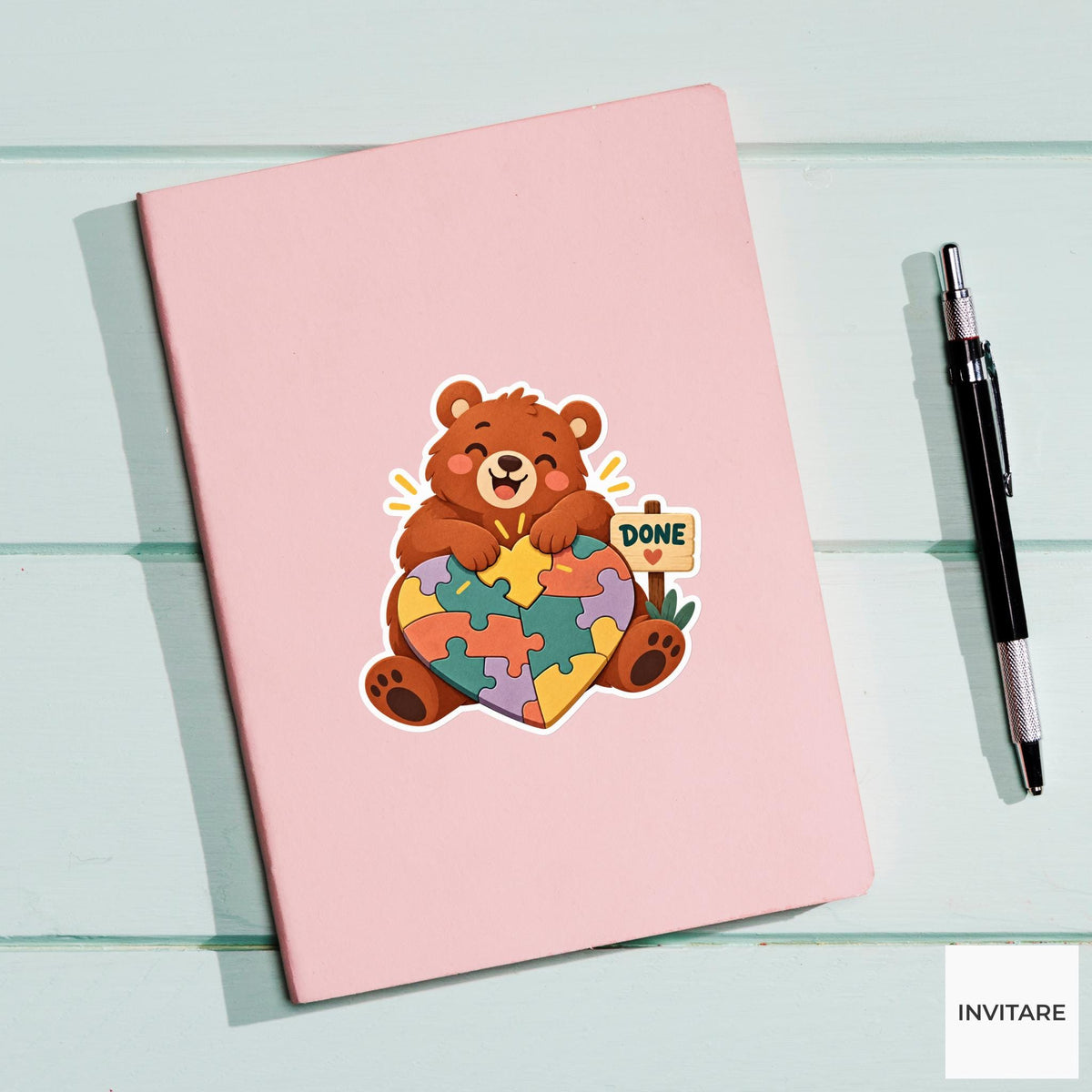 Bear celebrating as both paws press the last piece into a heart-shaped puzzle Vinyl Sticker