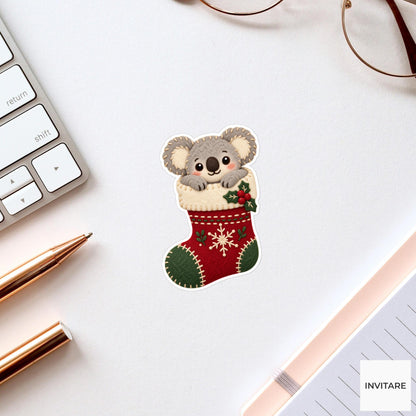 Koala hugging the top of a stocking while its round body stays tucked inside Vinyl Sticker