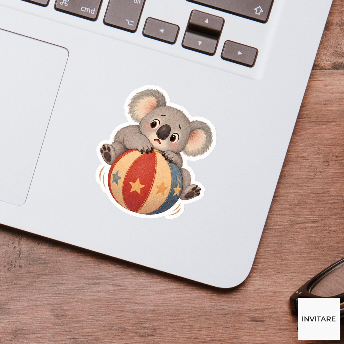 Koala sitting on a rolling ball with paws gripping tightly Vinyl Sticker