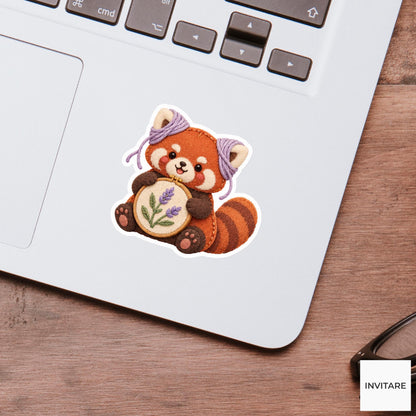 Red Panda wearing yarn around its ears while holding a hoop Vinyl Sticker