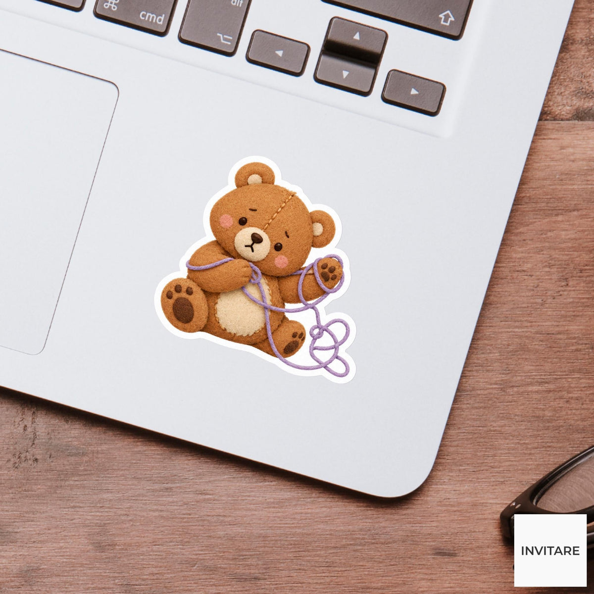 Bear trying to unravel a loop of thread from its paw Vinyl Sticker