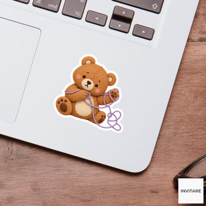 Bear trying to unravel a loop of thread from its paw Vinyl Sticker
