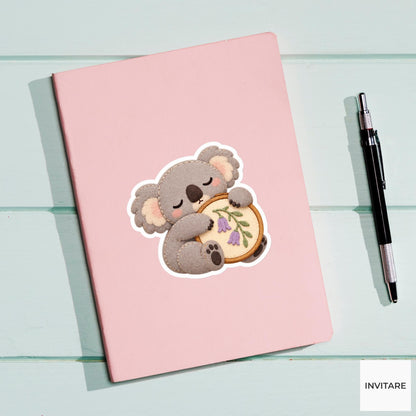 Koala hugging a fabric hoop while slowly falling asleep Vinyl Sticker