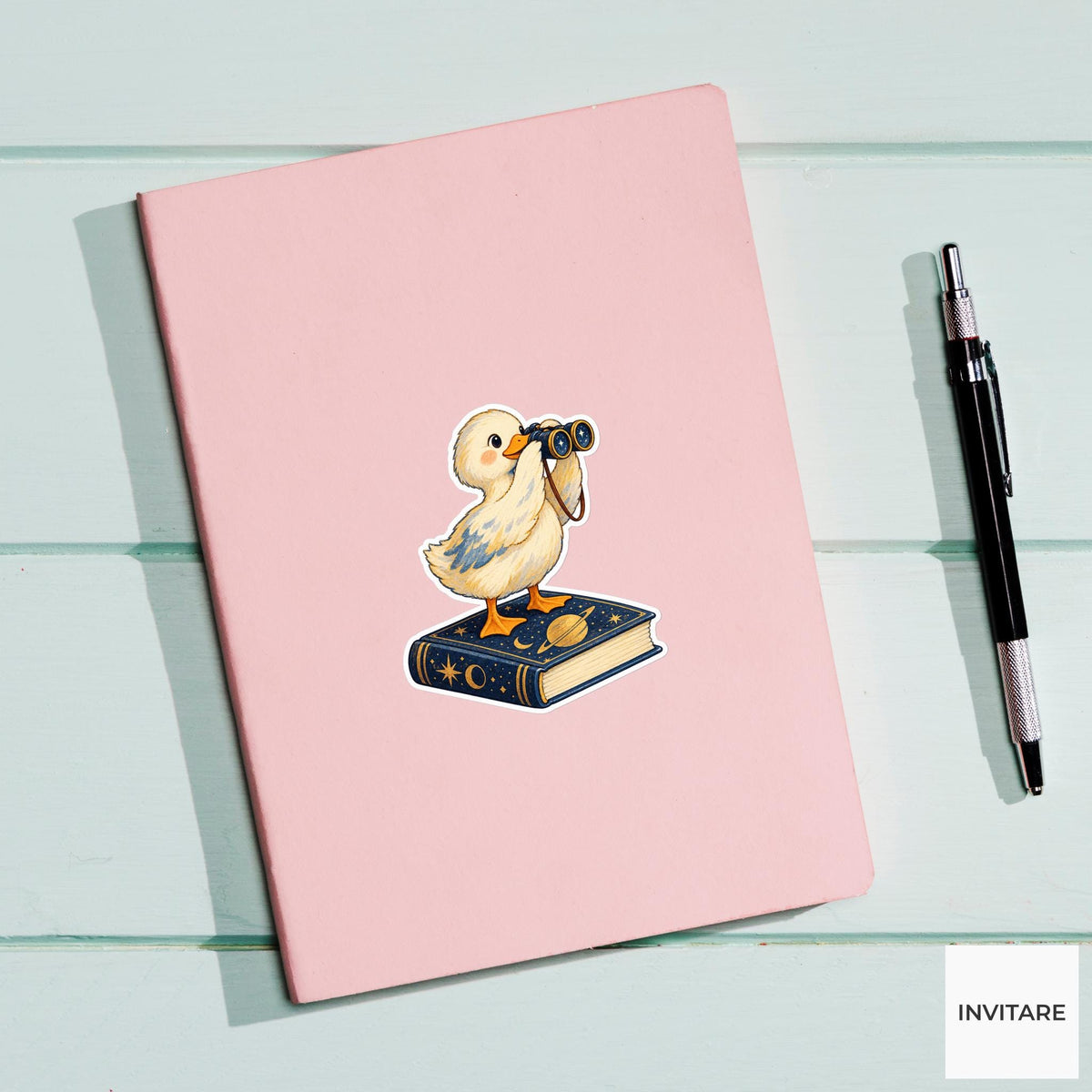 Duck looking through tiny binoculars while balancing on a closed astronomy book Vinyl Sticker